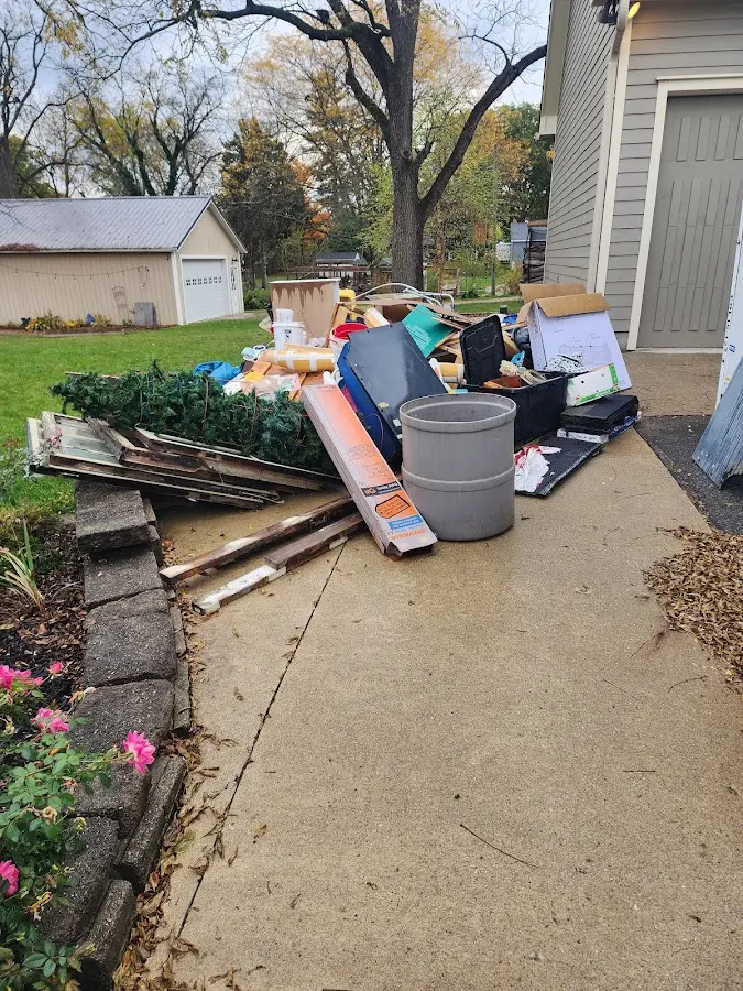 Dumpster being loaded with debris for 10 Yard Dumpster Rental in Lake Goodwin